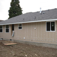 The back of the house. Windows installed and doors are going  in.