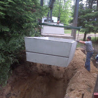 We dug a new whole (larger than before) and are now placing the new septic tank in the ground.